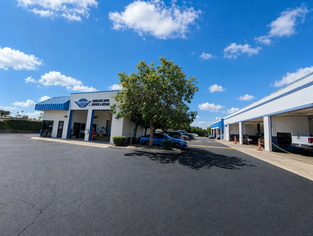 Exterior of Super Service of Pomona Valley on Foothill Boulevard with its service bays and parking lot