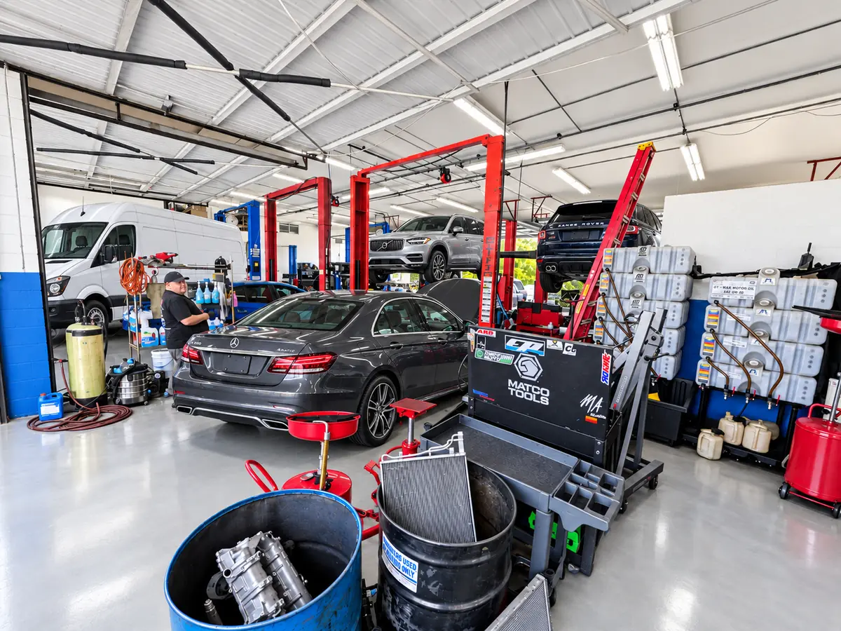 Service bays at Super Service of Pomona Valley with vehicles on two-post lifts